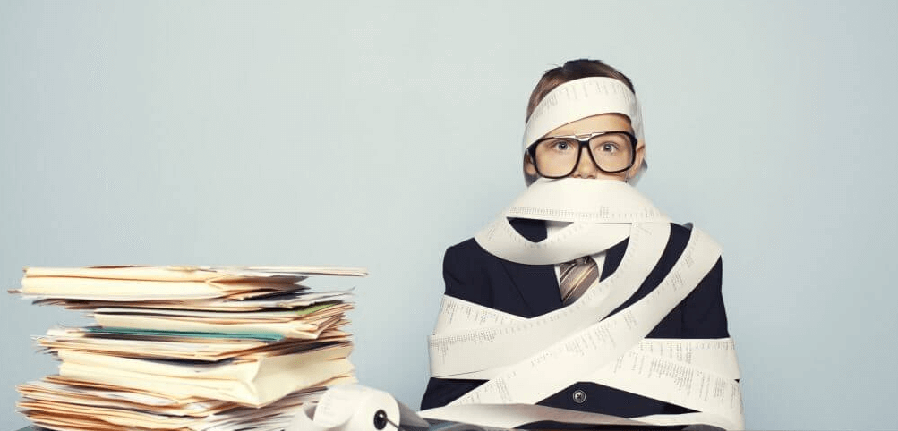 image of woman wrapped up in financial paperwork 